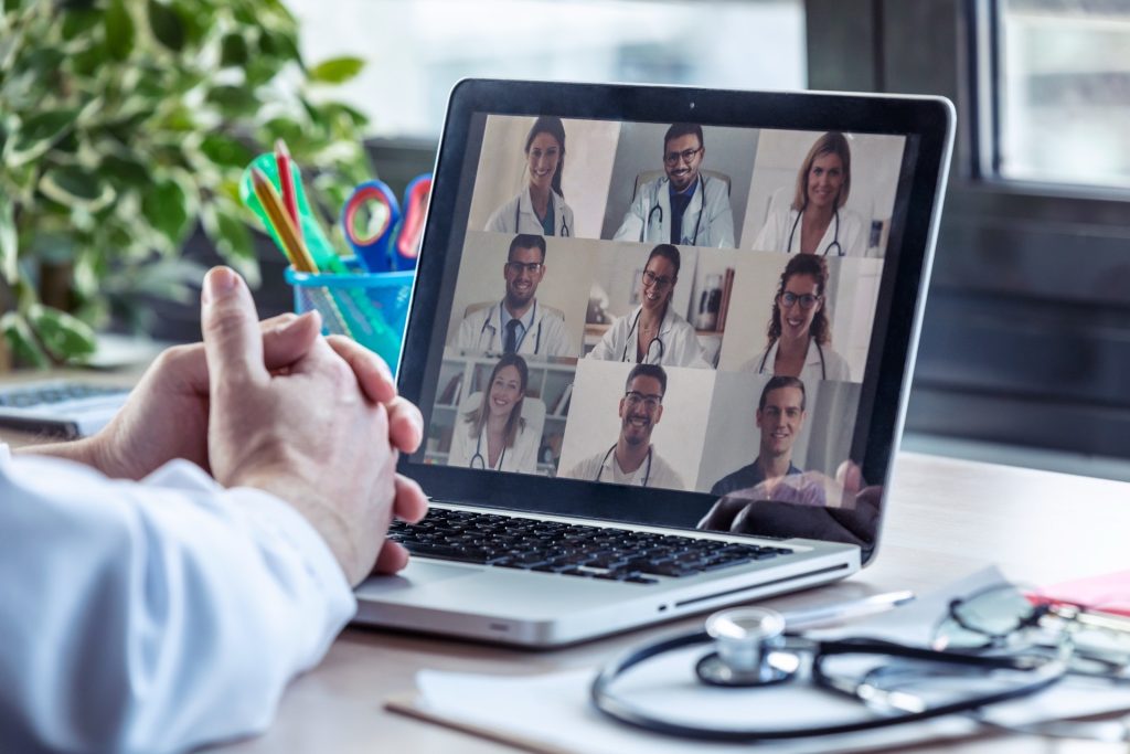 doctor having video conference on laptop with his colleagues