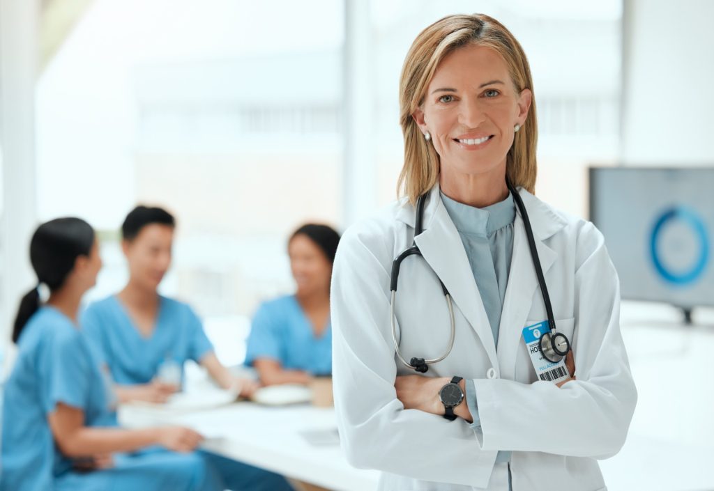 female doctor standing with her arms crossed at a hospital