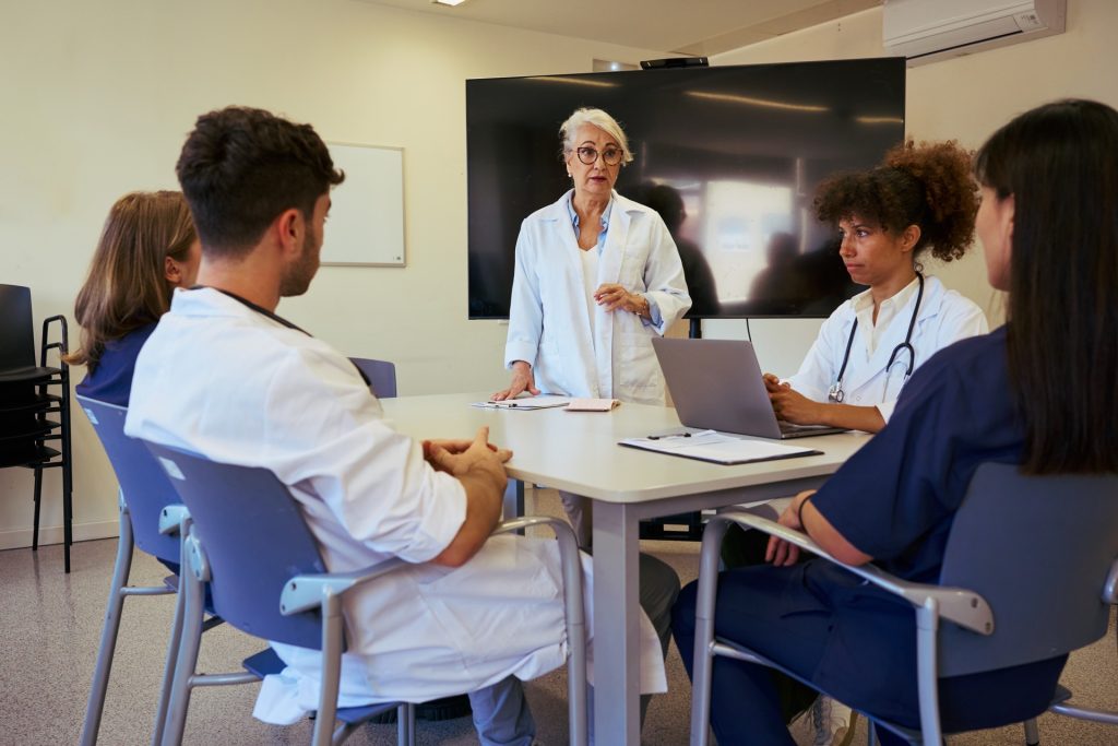 Medical team meeting discussing patient care in modern hospital