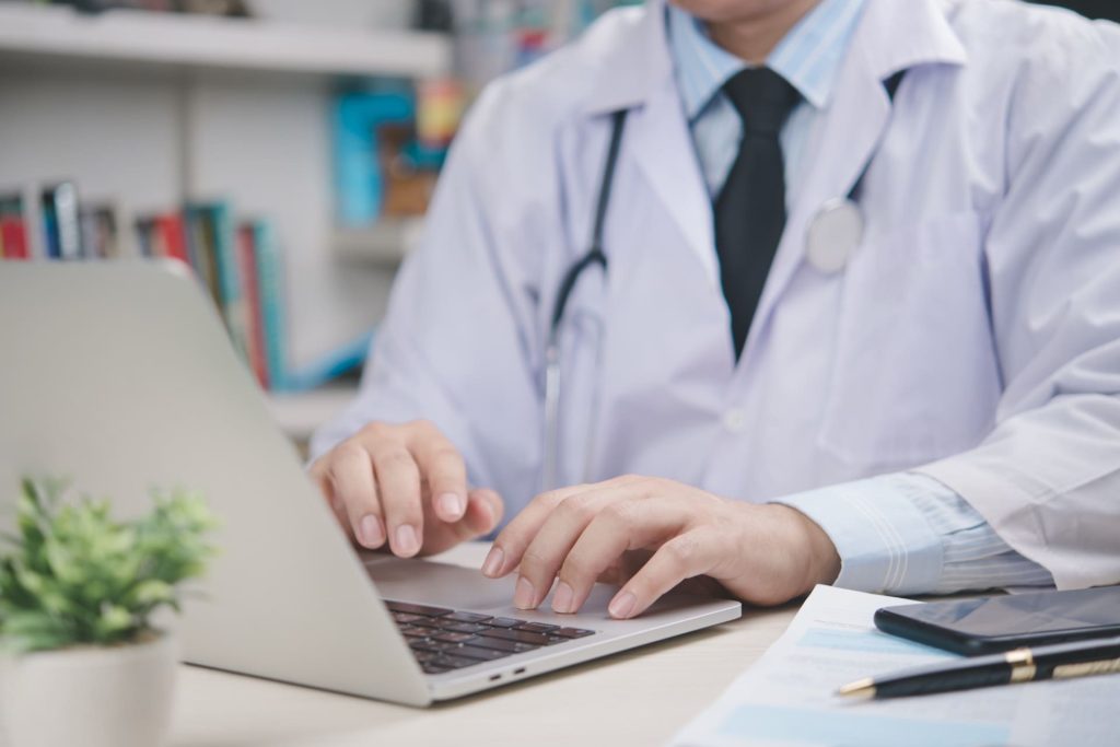 doctor on computer reviewing diabectic patient report