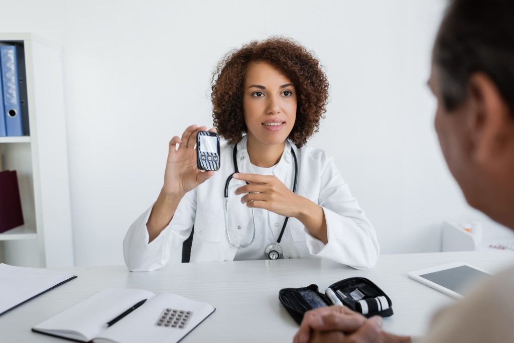 doctor pointing at glucometer