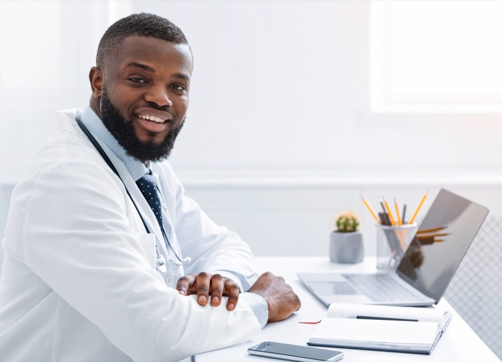 doctor working with laptop at clinic