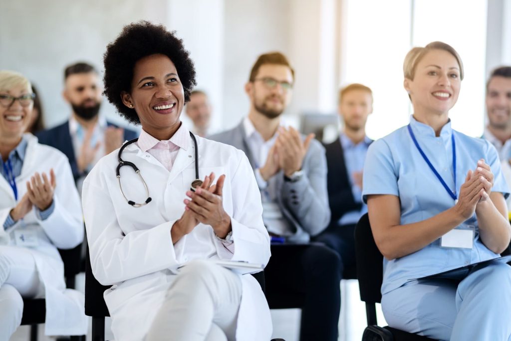 medical-professionals applaud at a conference